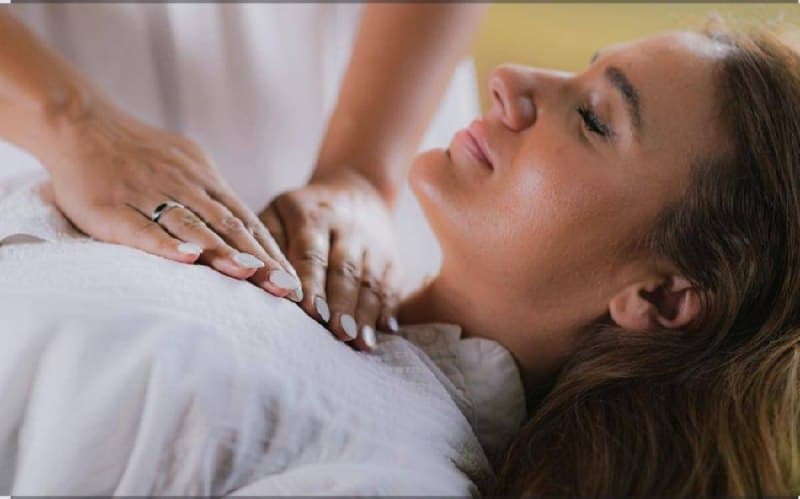 Gentle Reiki healing session with hands resting near the heart center